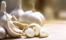 Cloves Garlic And Whole Garlic On The Wooden Table. Royalty Free Stock Image