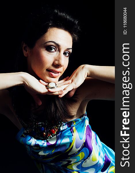 Fashion model with fantasy blue dress and colorful necklace posing with black background standing up. Studio shot. Fashion model with fantasy blue dress and colorful necklace posing with black background standing up. Studio shot