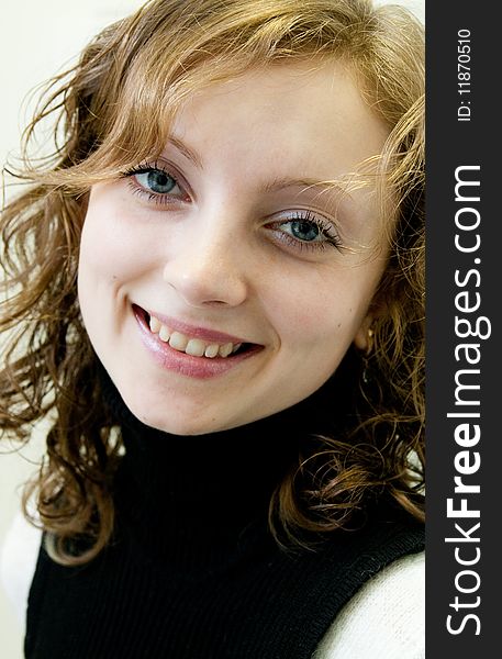 Portrait of young girl with a smile on face and by ringleted hairs. Portrait of young girl with a smile on face and by ringleted hairs