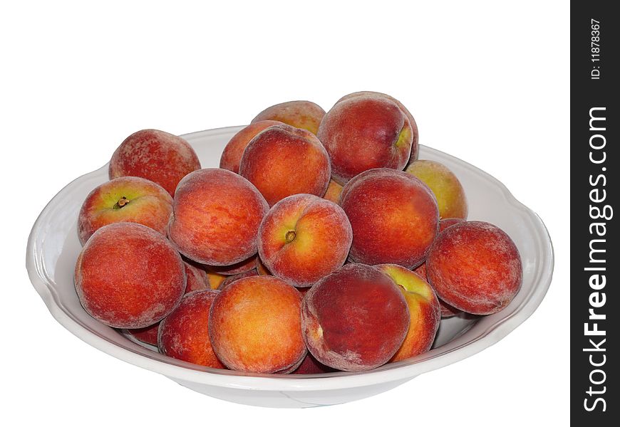Ripe peaches in plate. Isolated on white
