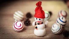 Toy Snowman And Gingerbread House At The Christmas Table Stock Photo