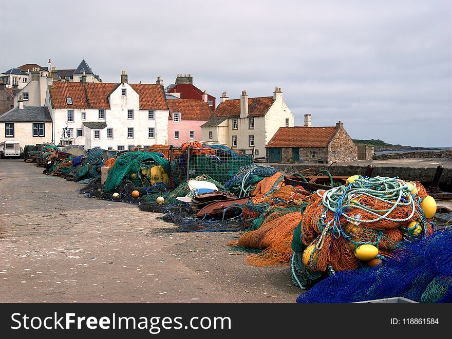 Fishing nets, buoys and houses at harbour at Pittenweem, Fife. Fishing nets, buoys and houses at harbour at Pittenweem, Fife