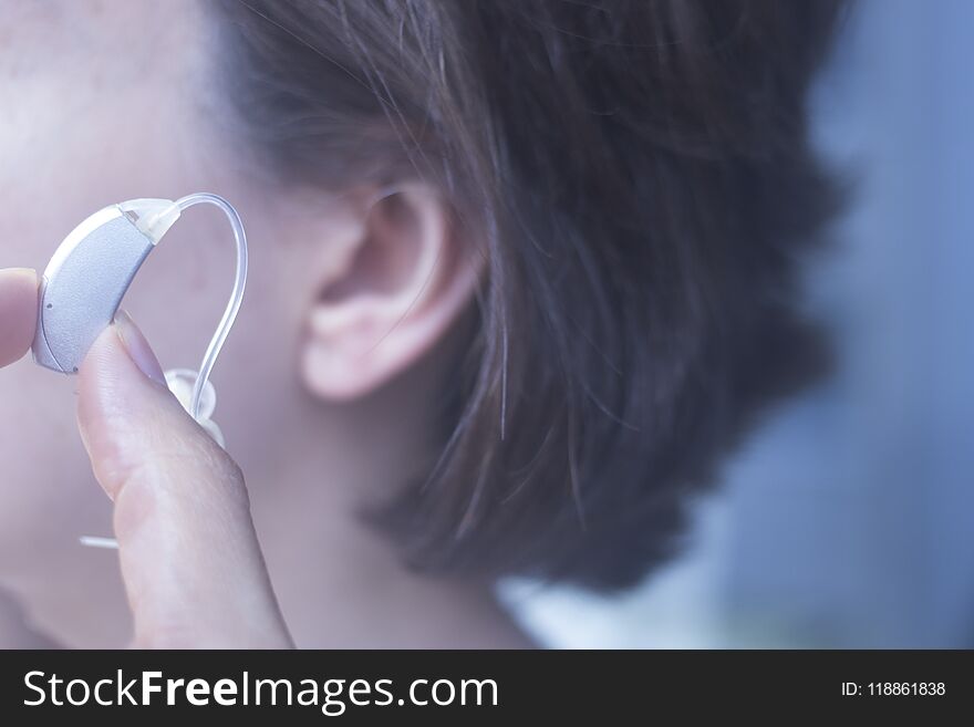 Deaf woman hearing aid ear