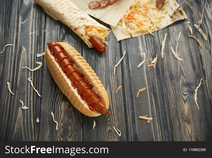 Fast food.hot dogs with sauce on wooden background