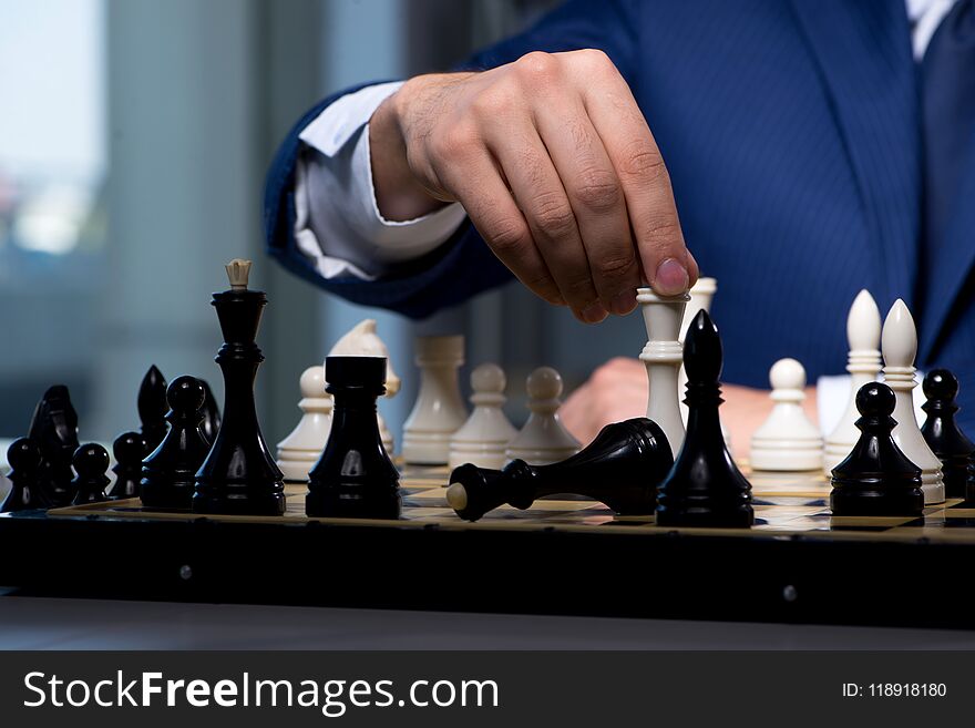 The businessman playing chess in strategy concept