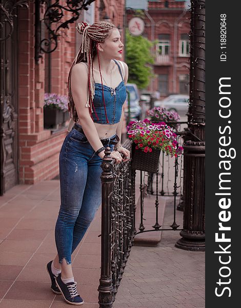 Woman Wearing Blue Crop Top Holding Handrails