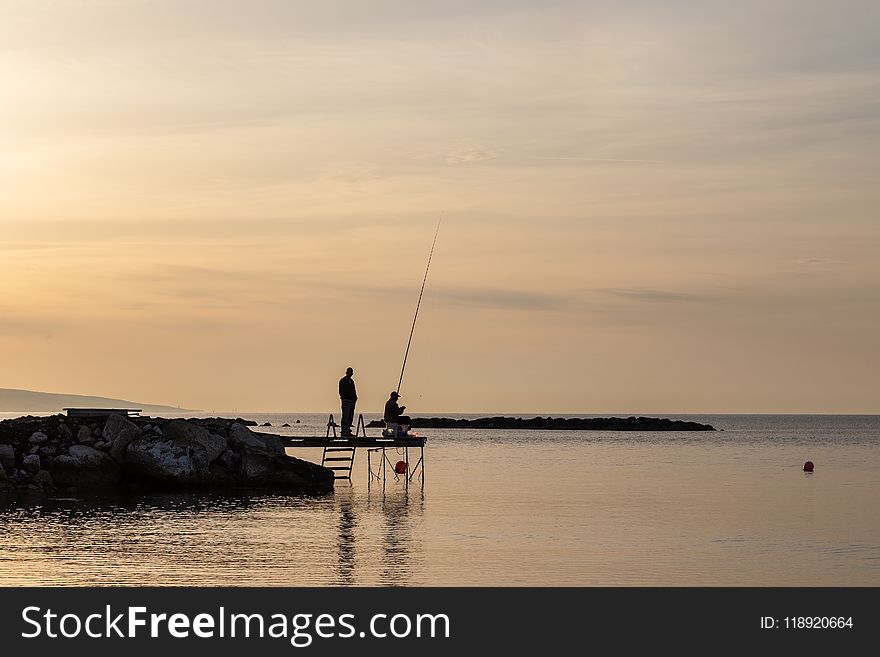 Two Person Having Fishing on Dock