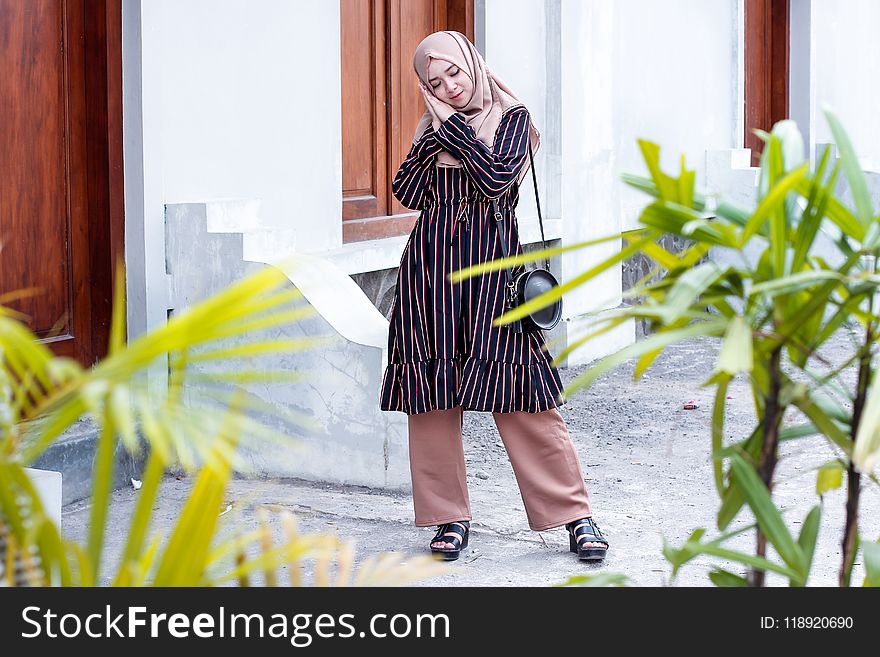 Woman Wearing Abaya Dress and Standing on Ground