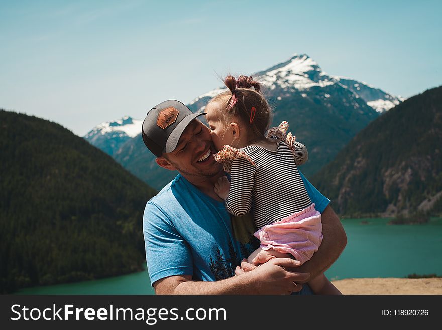 Man Carrying Her Daughter Smiling