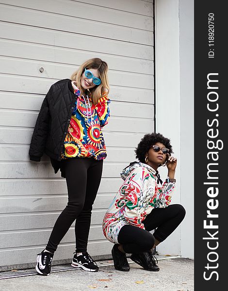 Women Wearing Multicolored Pullover Hoodie and Black Jacket