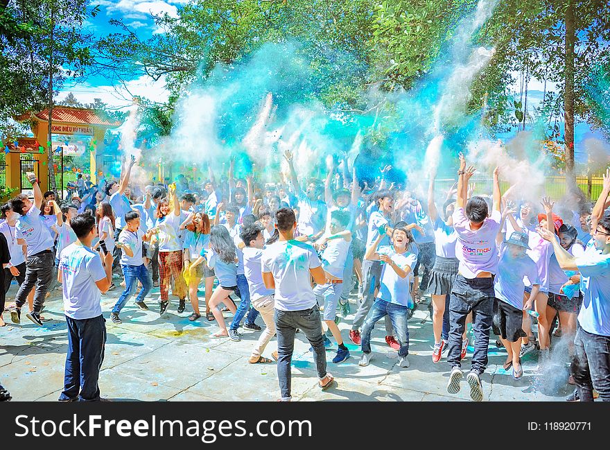 People Throwing Blue Powder at Daytime
