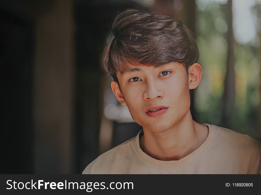 Selective-focus Photography Of Man Wearing Beige Crew-neck Shirt