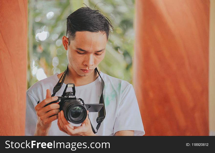 Person Holding Nikon Camera