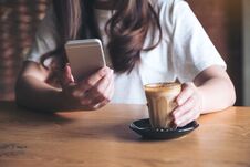 A Woman Holding , Using And Touching A Smart Phone While Drinking Coffee Stock Photos A Woman Holding , Using And Touching A Smart Phone While Drinking Coffee Stock Photos