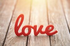 Word Love On Wooden Background In Sunset Stock Photo