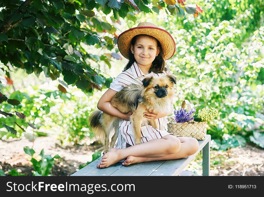 Portrait of a girl with a dog in the countryside
