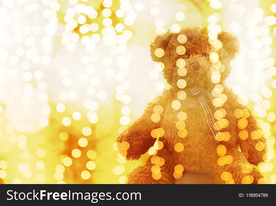 Teddy bear doll in Lighting line bokeh gold bright for Christmas or happy new year Background, Bear in glitter Gold yellow