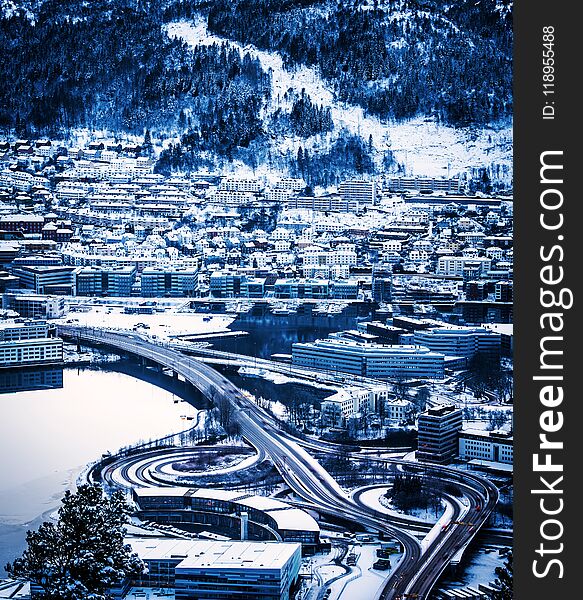 View from the mountains to Bergen in winter, city with roads, Norway