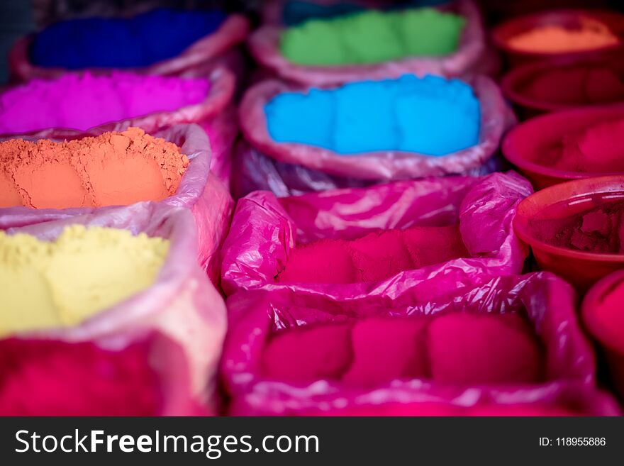 Colorful natural rangoli powders on street marker, close-up. Colorful natural rangoli powders on street marker, close-up