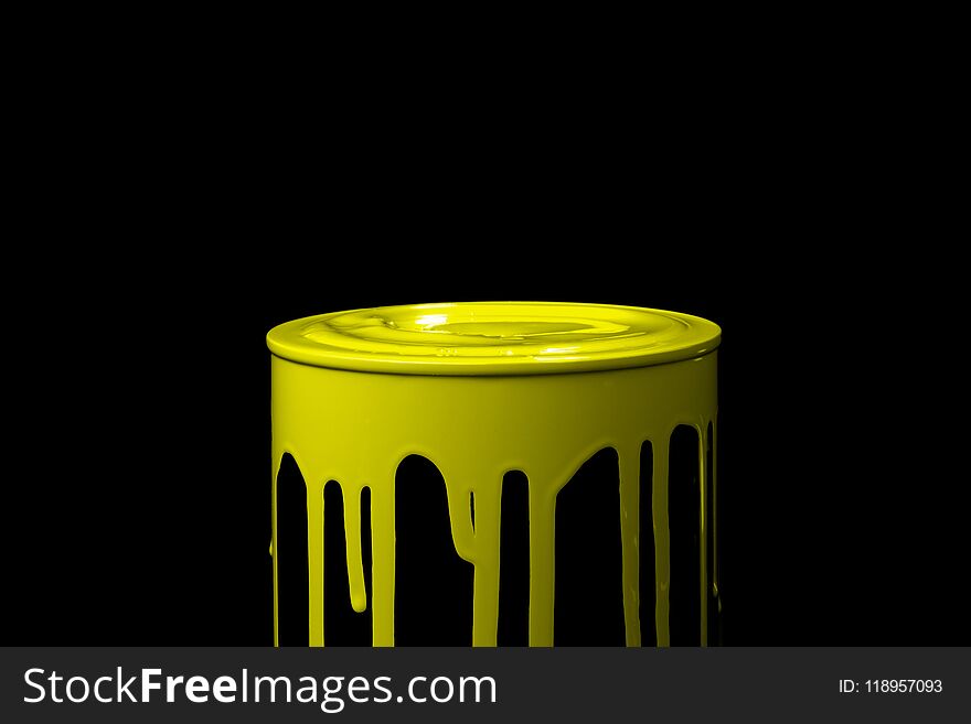 Yellow oil paint flowing over the part of metal bucket. Isolated