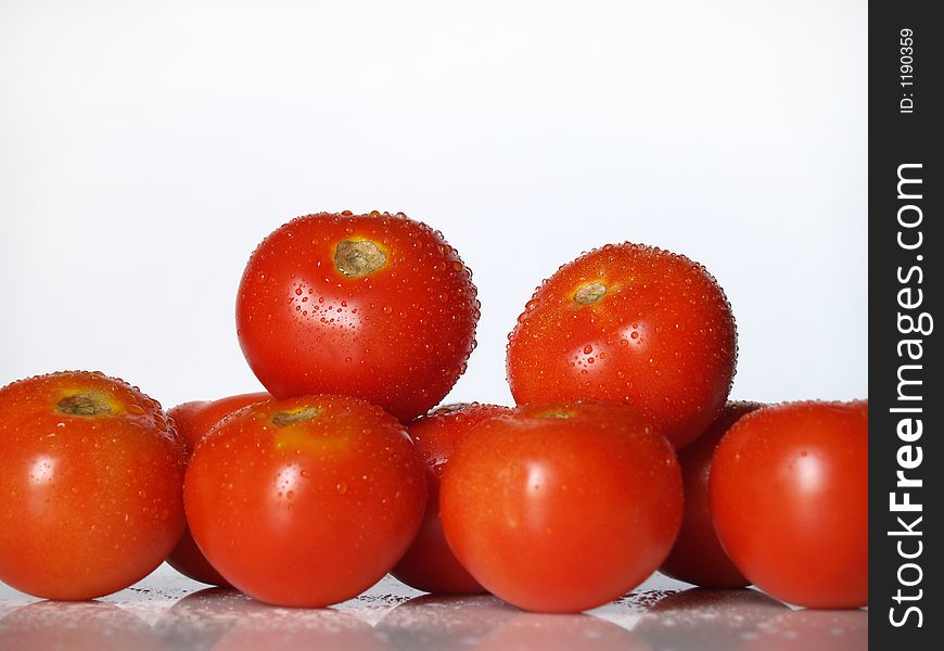 Fresh tomatoes over white surface