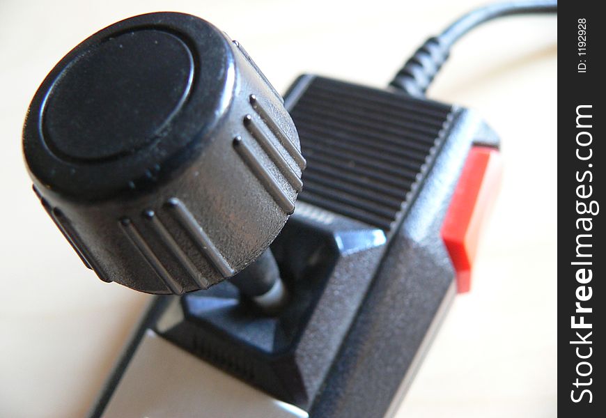 An old vintage retro video game joystick controller.