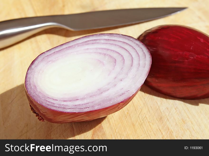 Onion On Chopping Board With Knife