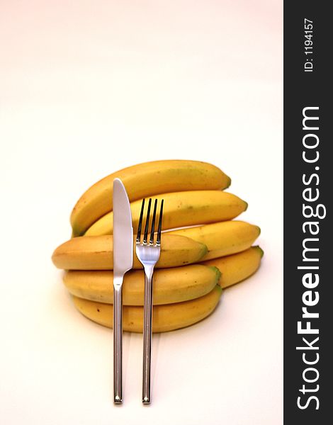 Bananas with a fork and a knife, A natural dessert. Bananas with a fork and a knife, A natural dessert