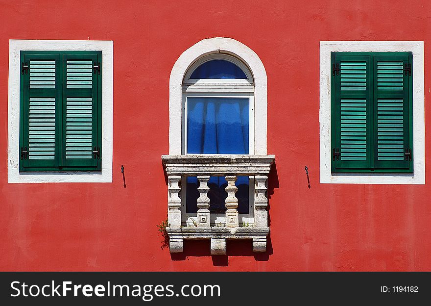 Green and red building at the sea shore. Green and red building at the sea shore