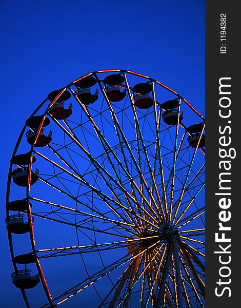 Ferris Wheel at twilight with deep blue sky. Ferris Wheel at twilight with deep blue sky.