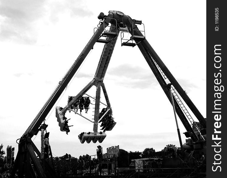 A black and white image of a fairground ride. A black and white image of a fairground ride.