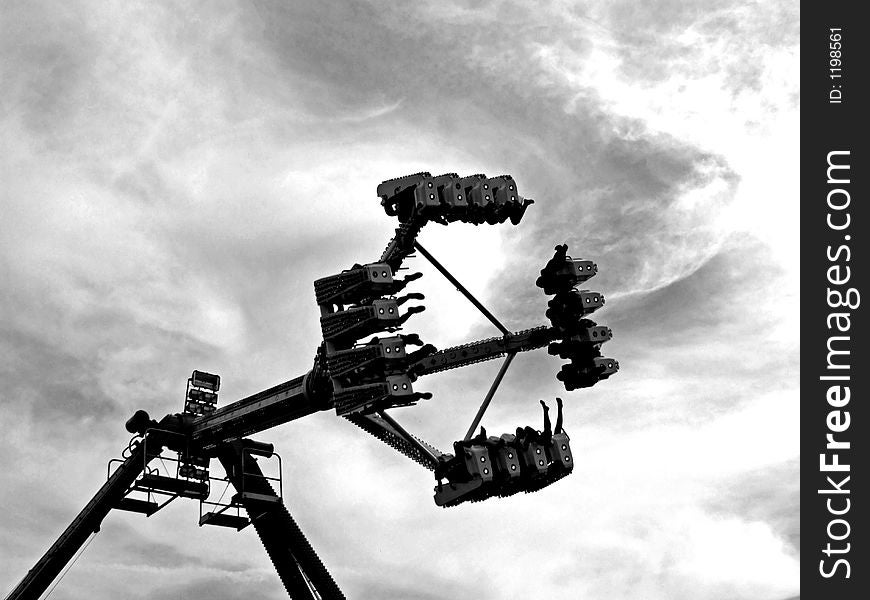 A black and white image of a fairground ride.