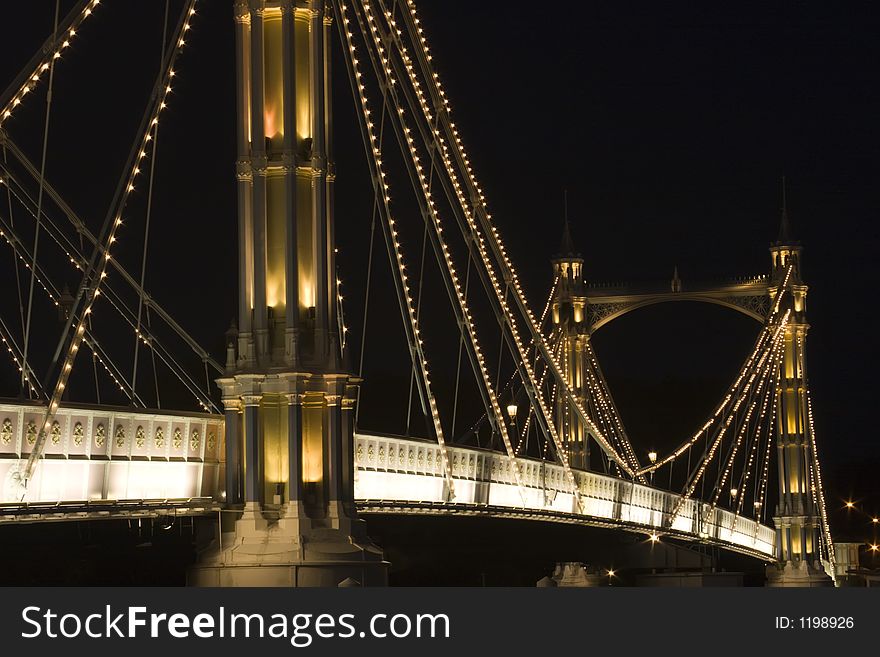 A Close up view of The albert Bridge at night in London.