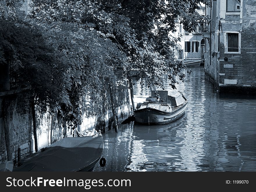 A sepia tone and artistic view down one of the canals in Venice. A sepia tone and artistic view down one of the canals in Venice.