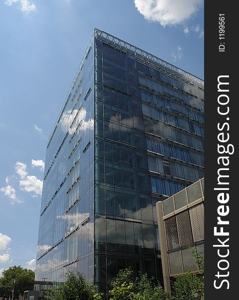 A modern glass and steel office building in a town in Germany.
