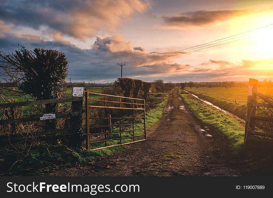 Brown Farm Gate And Green Grass Field