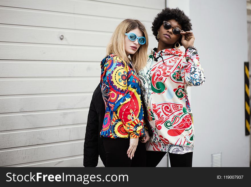 Two Women Standing Near Roller Shutter