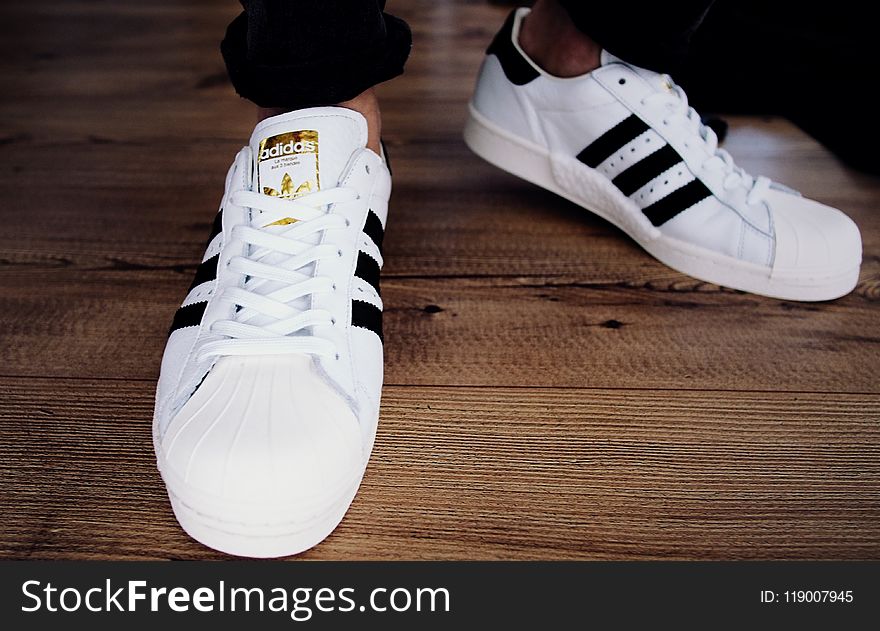 Pair of White-and-black Adidas Superstars