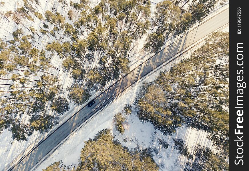 Snowy Road With A Moving Car In Winter