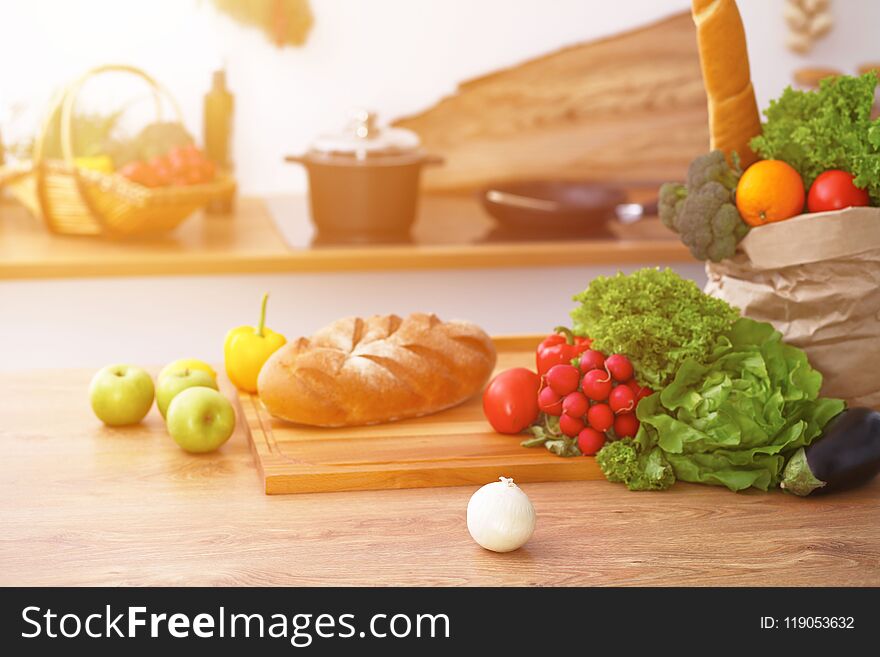 Desk with many fresh vegetables and fruits in the kitchen. Cooking, vegetarian and shopping concept.