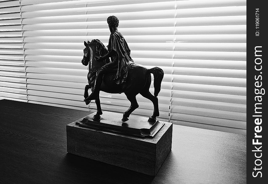 Man Riding On Horse Figurine