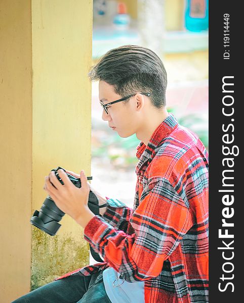 Photography of a Man Holding Black Camerar