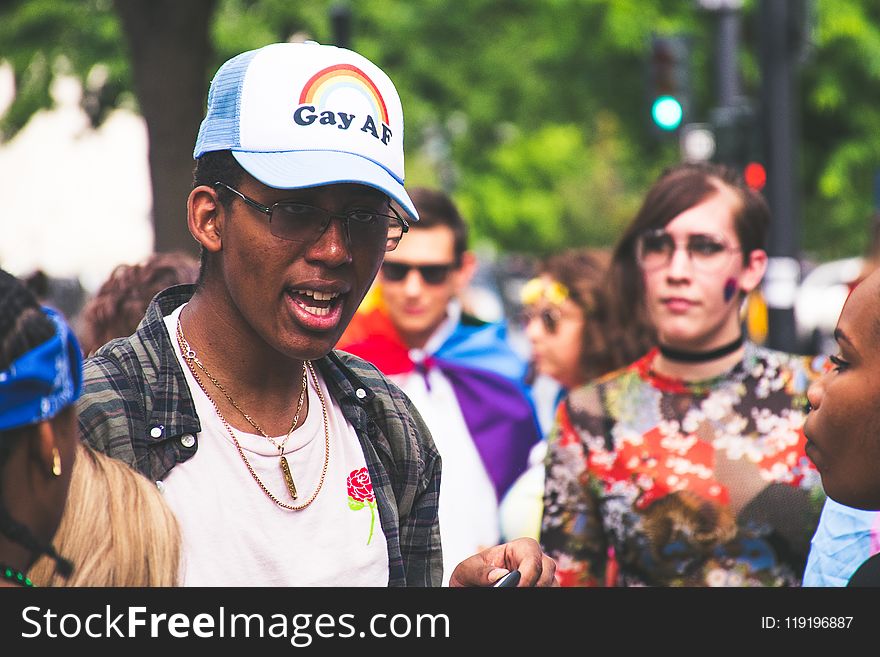 Man With White Crew-neck Shirt Beside Woman With Multicolored Shirt At Daytime