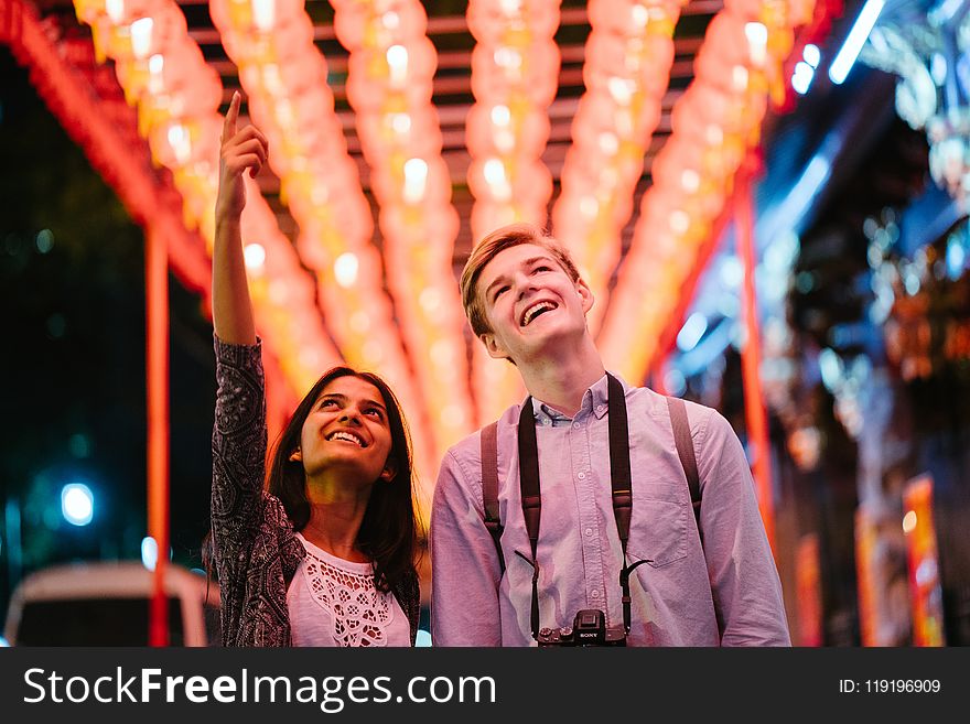 Photo of Man and Woman Looking Up