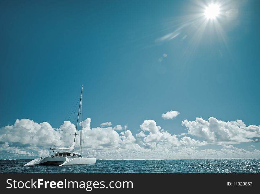 Sailboat on the water with horizon and clouds in the background on a sunny summers day. Sailboat on the water with horizon and clouds in the background on a sunny summers day