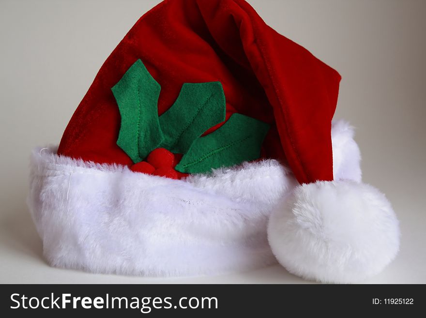 Santa Claus hat with holly leaves. Santa Claus hat with holly leaves