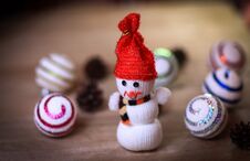 Toy Snowman And Gingerbread House At The Christmas Table Royalty Free Stock Image