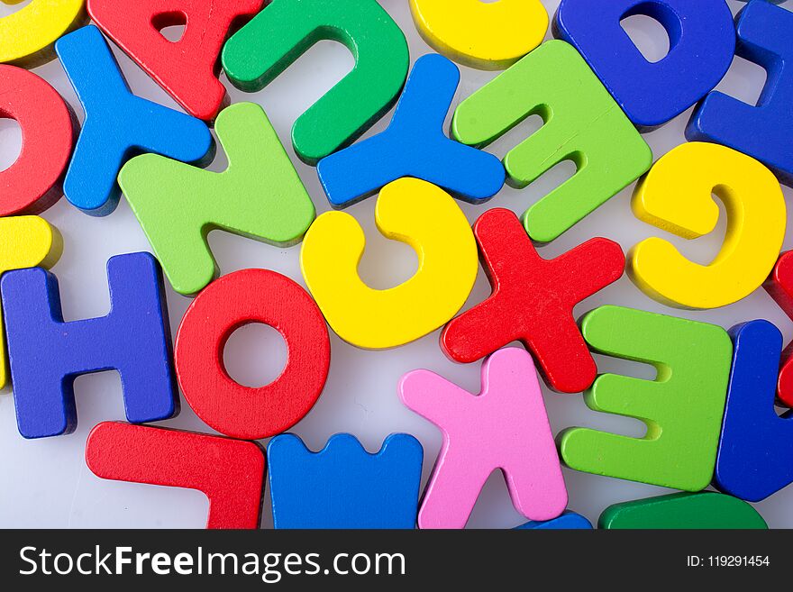 Colorful alphabet letter blocks scattered randomly on white background. Colorful alphabet letter blocks scattered randomly on white background