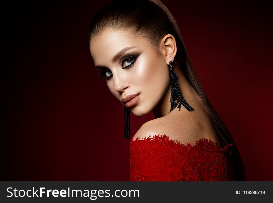 Fashion photo of young magnificent woman in luxury dress.