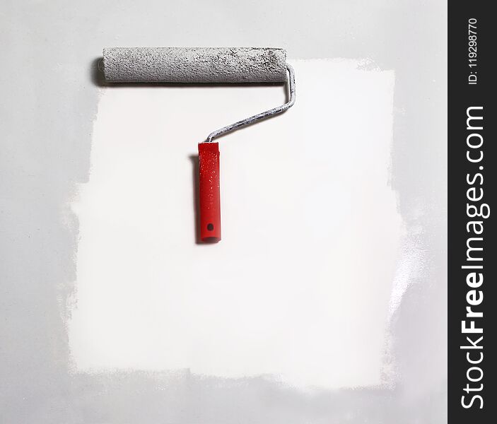 Paint roller painting on white paper.background.place for text